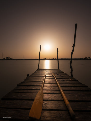 Rame sur un ponton bois, lors d'un lever de soleil au Cap-Ferret.